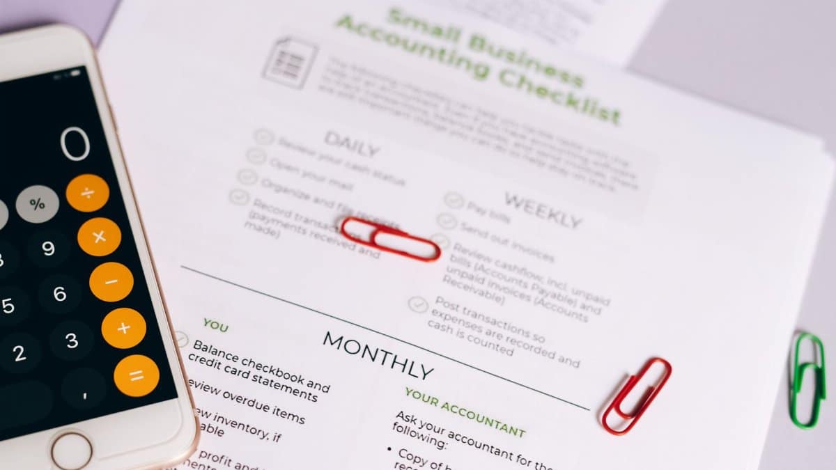 Image of a checklist and calculator for managing small business accounting tasks efficiently.