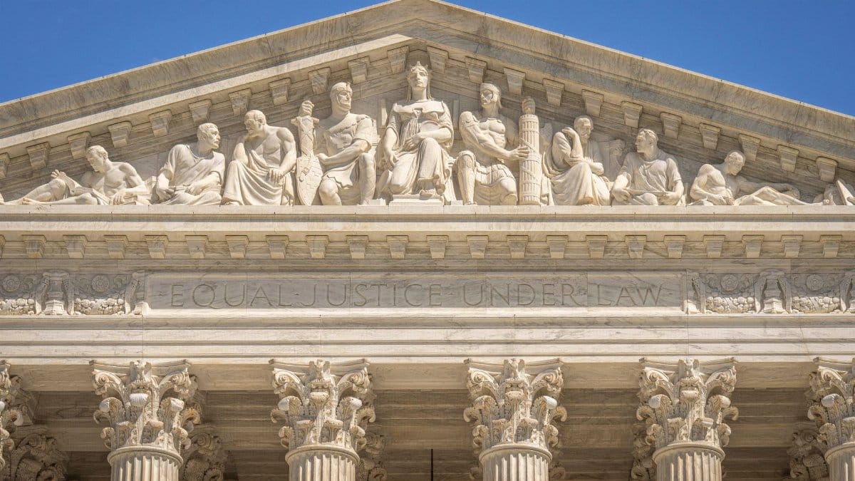 Detailed view of the Supreme Court Building's frontal frieze depicting historical figures and justices.