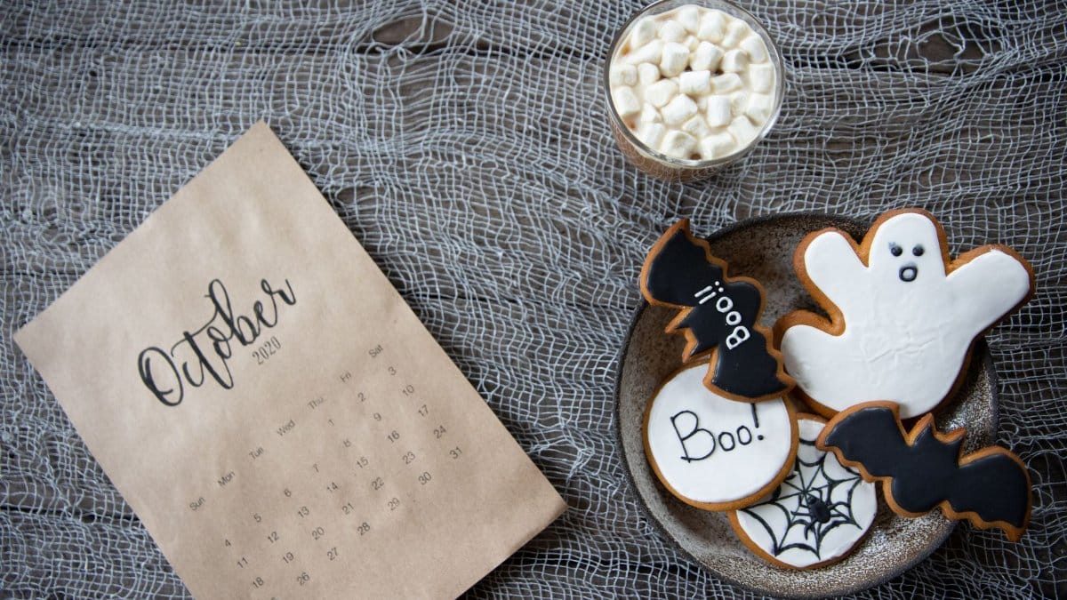 Halloween themed cookies and October calendar on a rustic background, perfect for festive holiday design