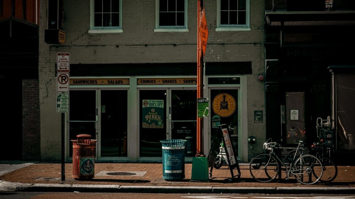 Street view of a cafe facade in Washington, DC. Includes bicycles and signs, ideal for urban lifestyle visuals.