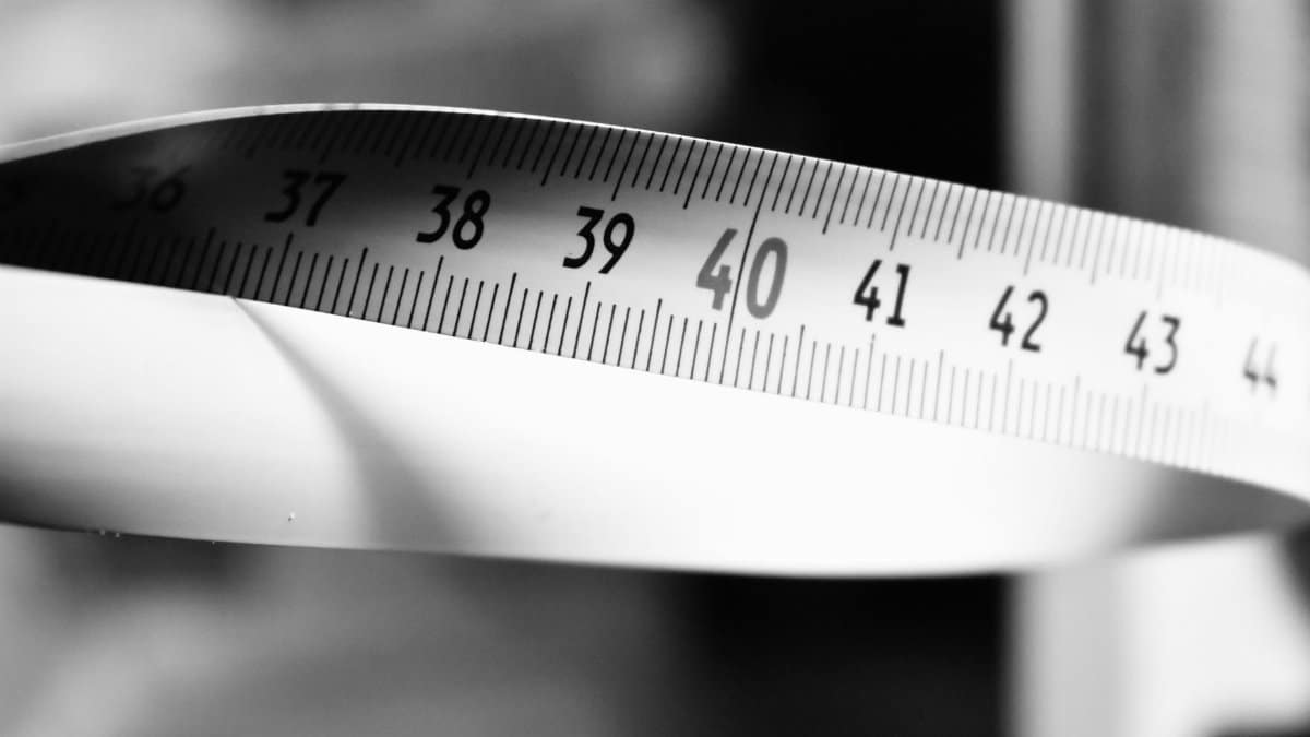 Artistic black and white photo of a measuring tape showing numbers 36-44.
