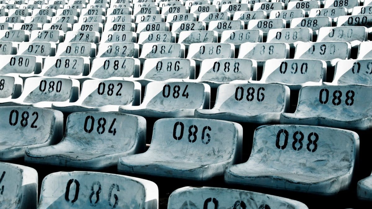 Rows of numbered stadium seats in Quito, Ecuador, create a striking visual with repeating patterns and cool tones.
