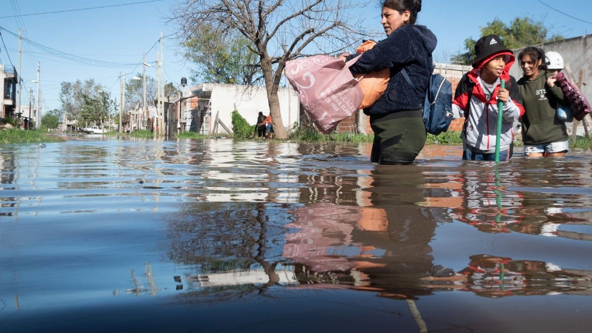 People wade through flooded streets in Buenos Aires, Argentina, after heavy rainfall.