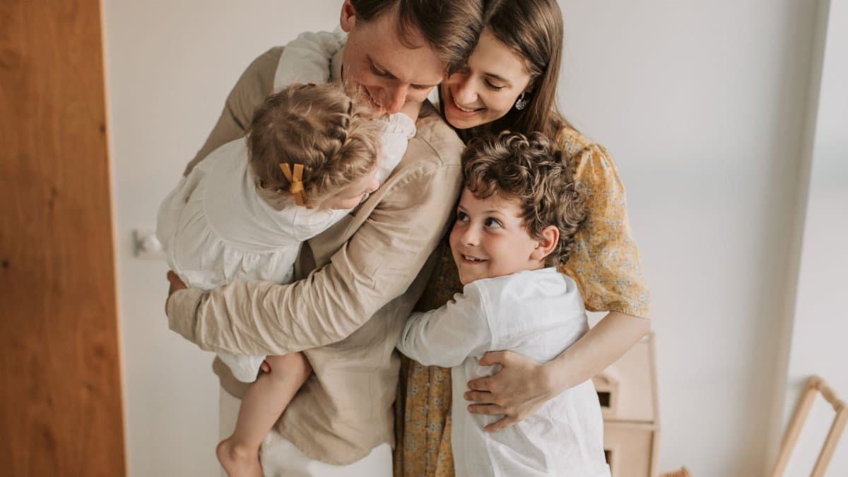 A heartwarming scene of a family hugging indoors, showcasing love and togetherness.