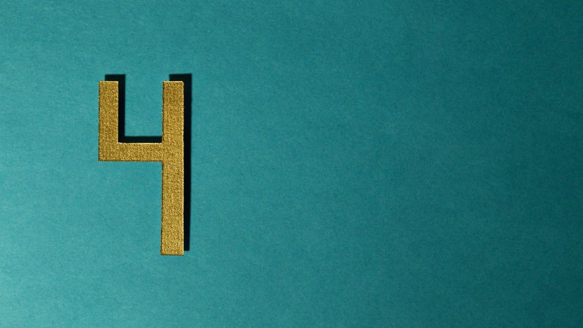 Elegant golden number four on teal background ideal for modern design.