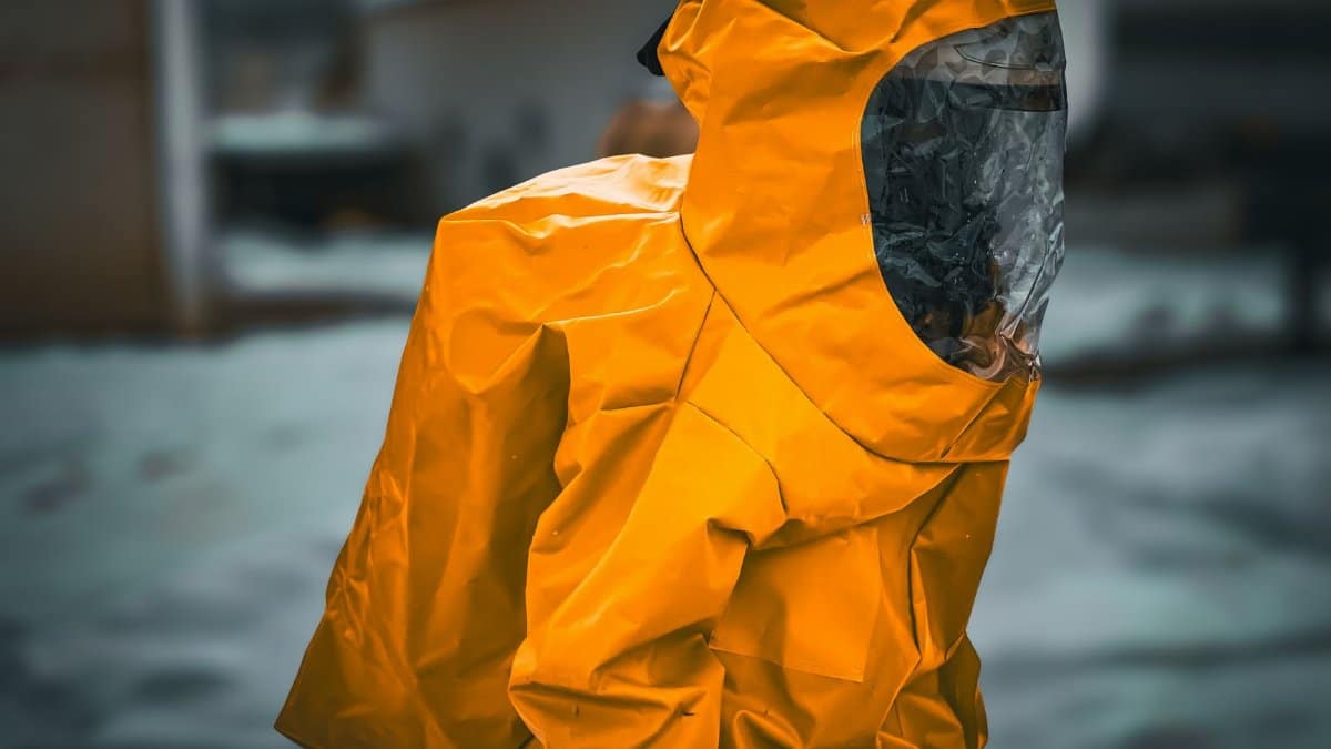 A person wearing a yellow hazmat suit is standing outdoors, creating a dramatic and vivid scene.