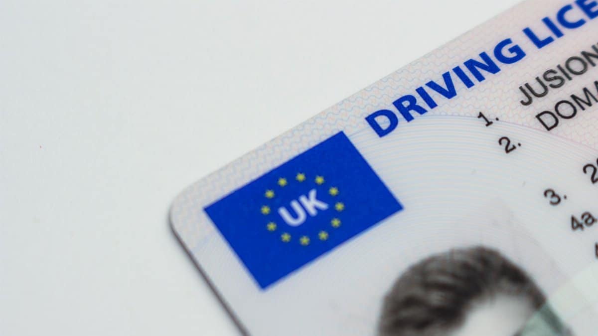 Detailed photo of a UK driving license showcasing EU flag and identity features.