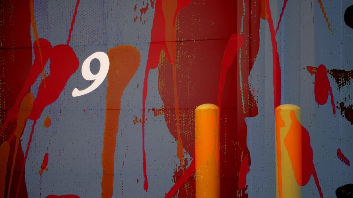 Colorful abstract mural featuring the number nine and bold paint splashes.