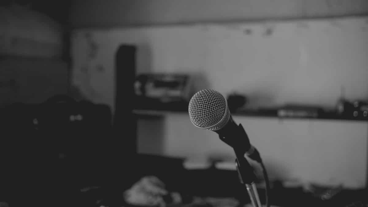 Artistic black and white shot of a music studio with a focus on a microphone. Perfect for music-themed projects.