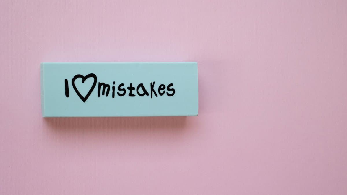 Minimalist eraser with 'I Love Mistakes' message on pink background, school stationery.