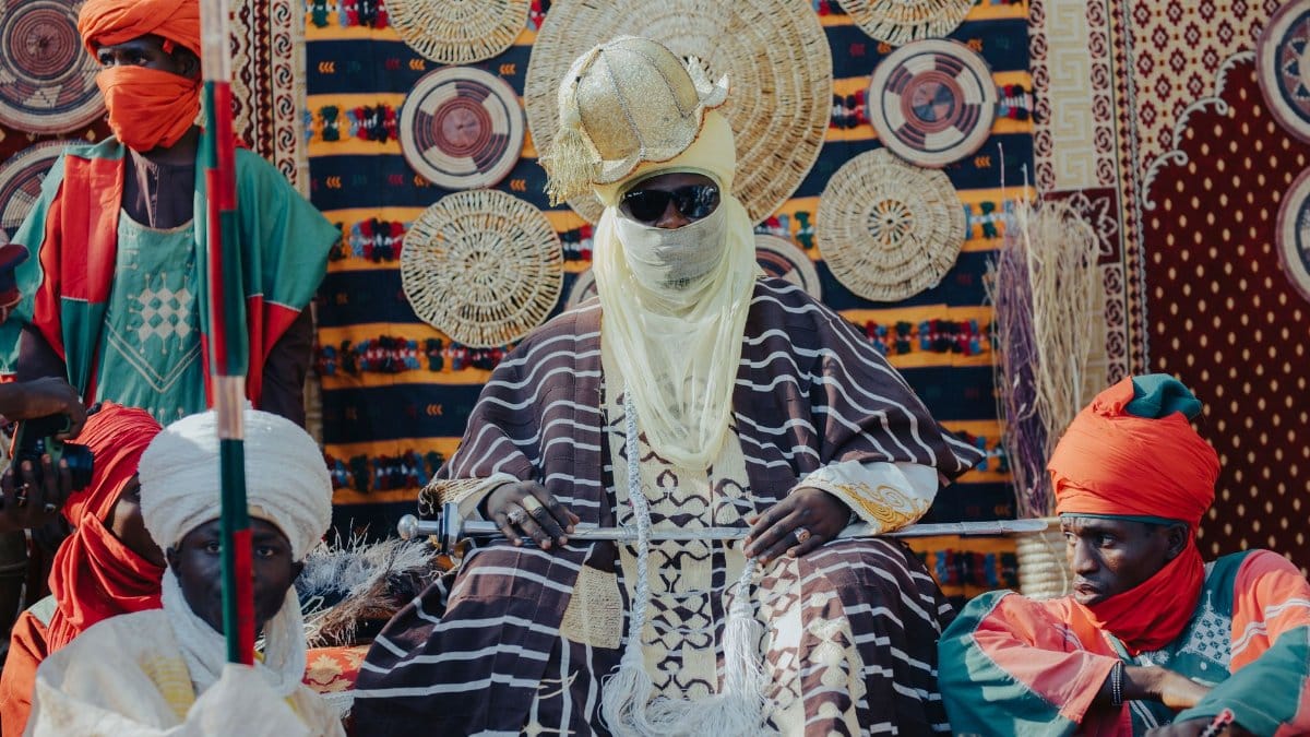 Colorful display of traditional African attire at tribal gathering.