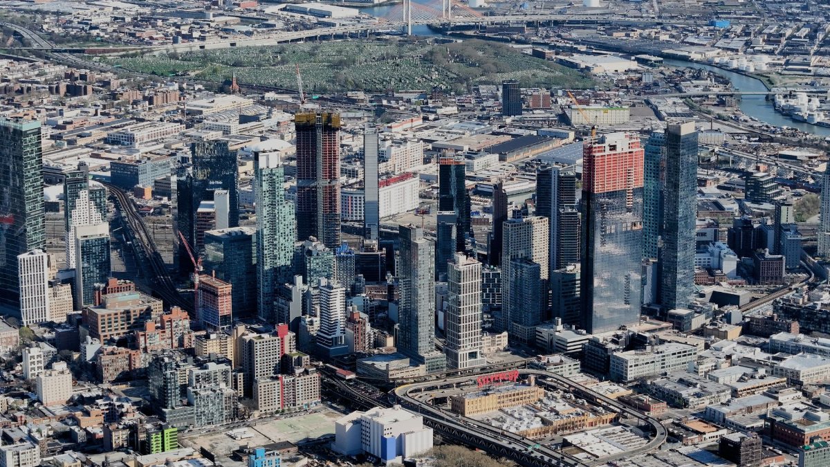Dynamic aerial view of New York City skyline showcasing high-rise skyscrapers and urban landscape.
