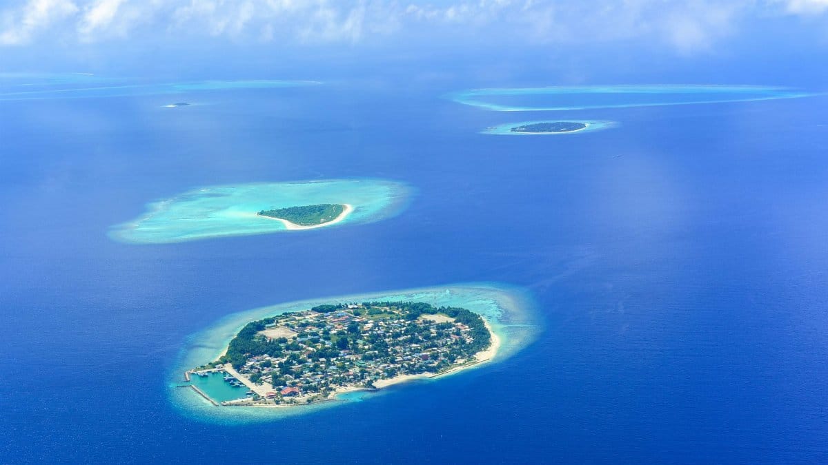 Stunning aerial view of Maldives islands surrounded by clear turquoise waters.