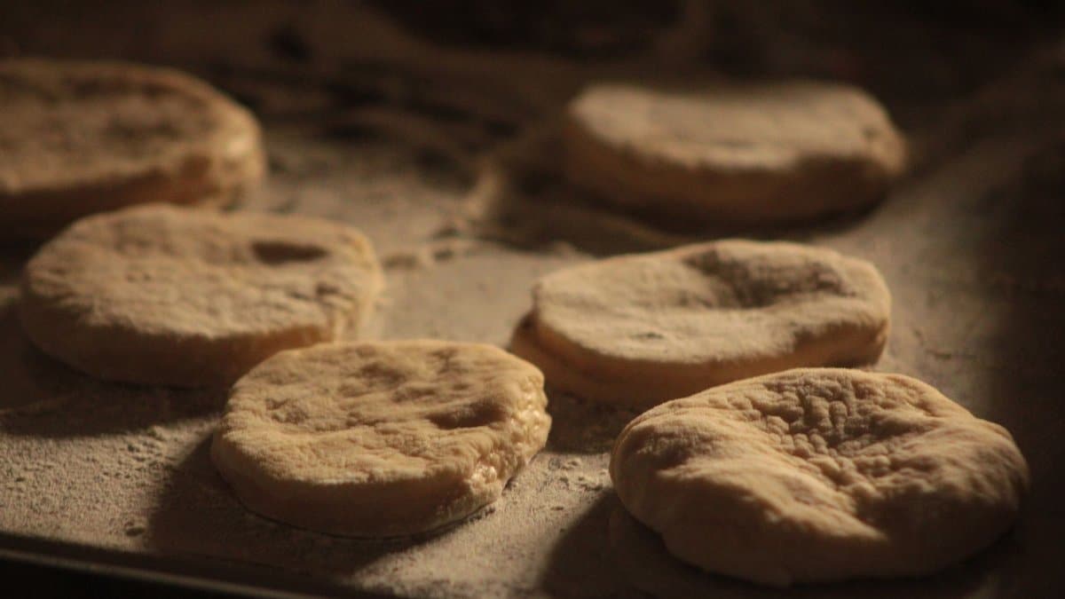 Close-up of raw dough pieces resting on a floured surface, ready for baking.