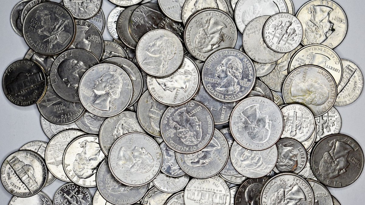 A detailed collection of various US coins including quarters, nickels, and dimes.