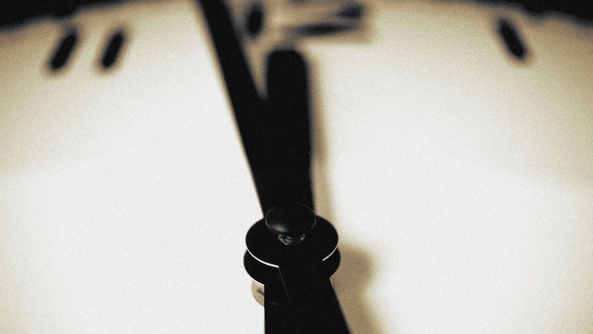 Artistic close-up of a blurred clock face emphasizing the passage of time.
