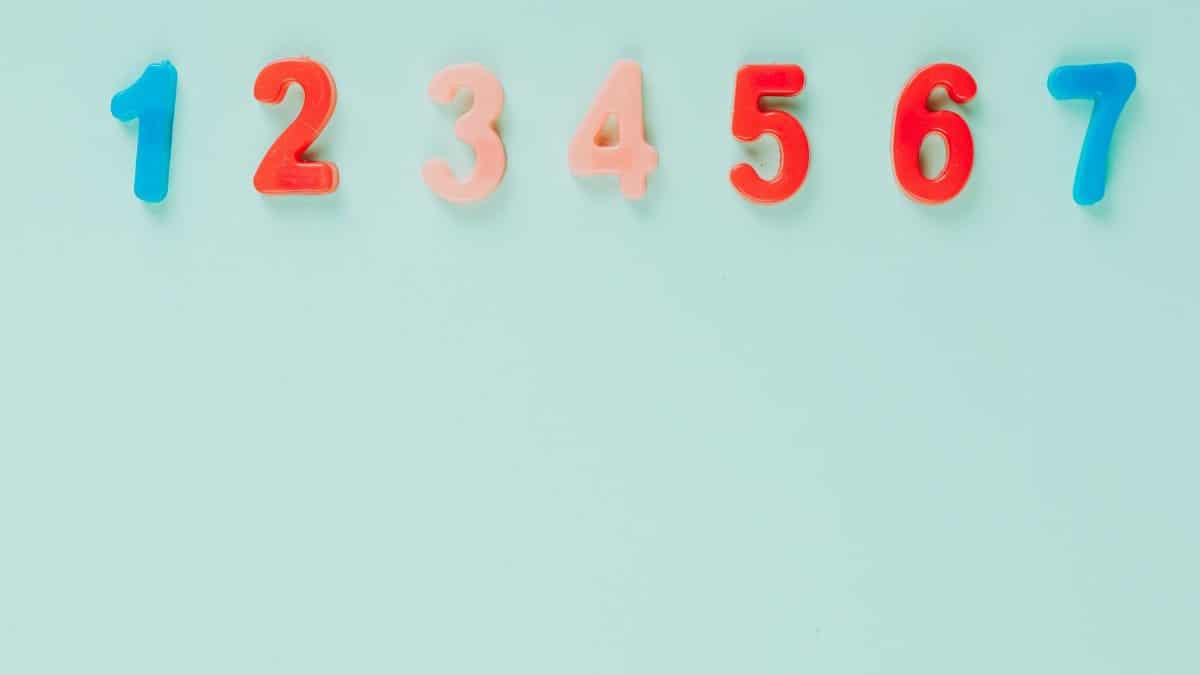 Bright plastic numbers on a blue background with ample copy space, ideal for educational themes.