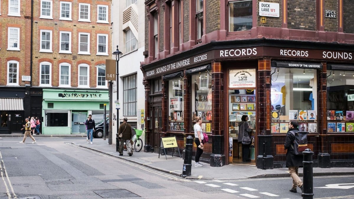 Vibrant London street with pedestrian traffic and iconic record store.