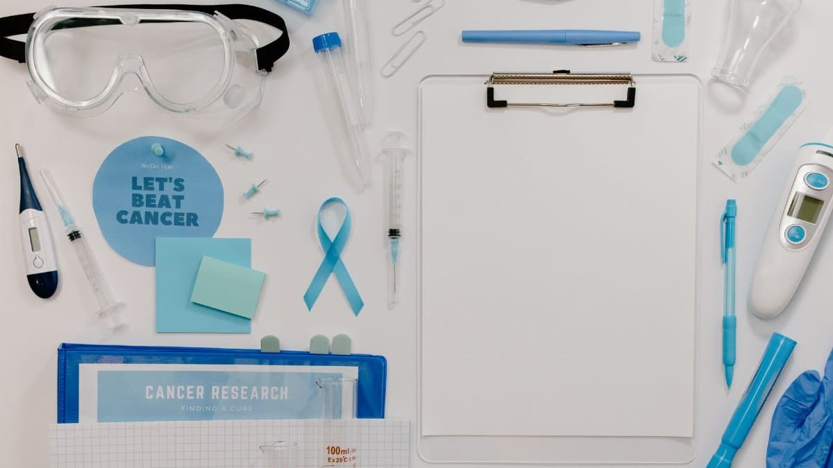 Flat lay of medical tools and cancer awareness symbols promoting cancer research and healthcare.