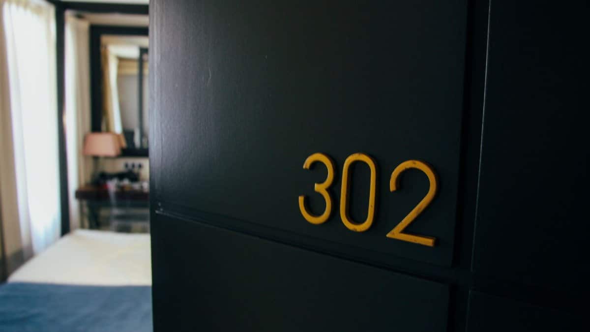 Stylish hotel room with room number 302 and elegant interior design.