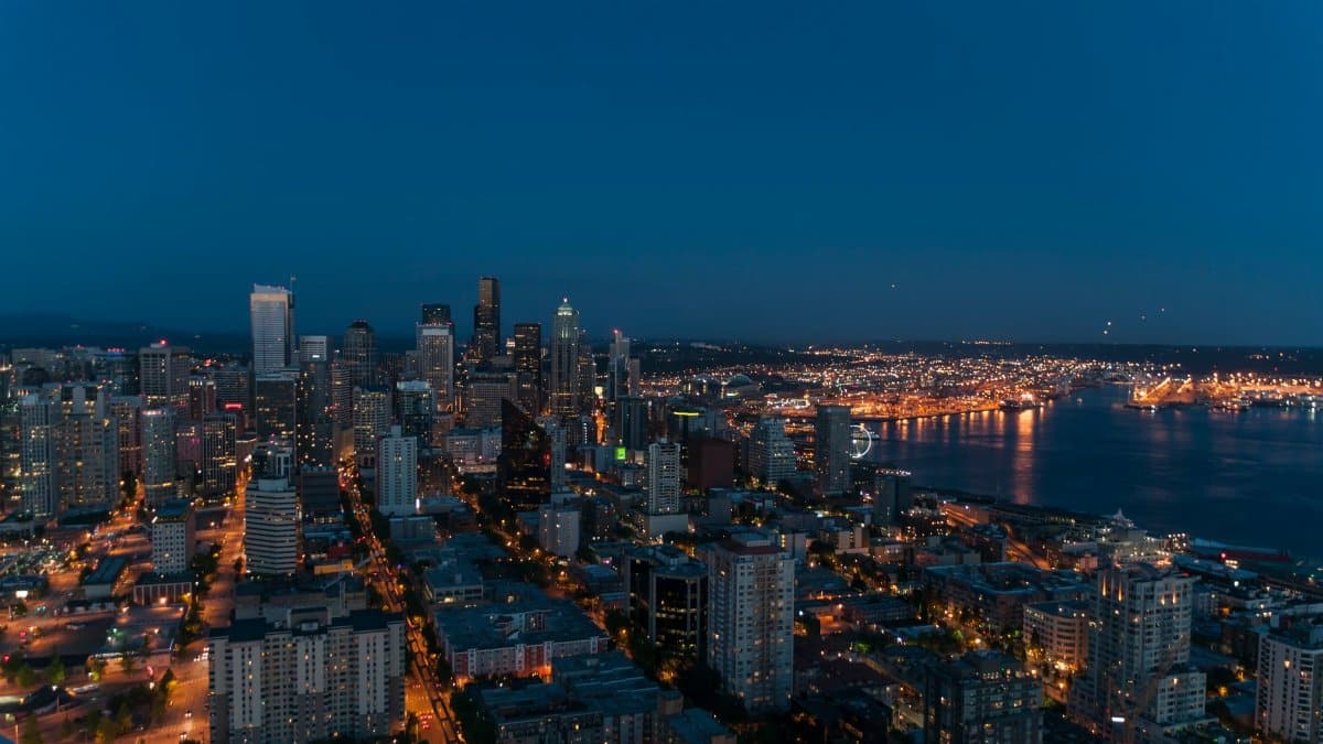 A breathtaking view of Seattle's skyline at twilight with city lights illuminating the urban landscape.