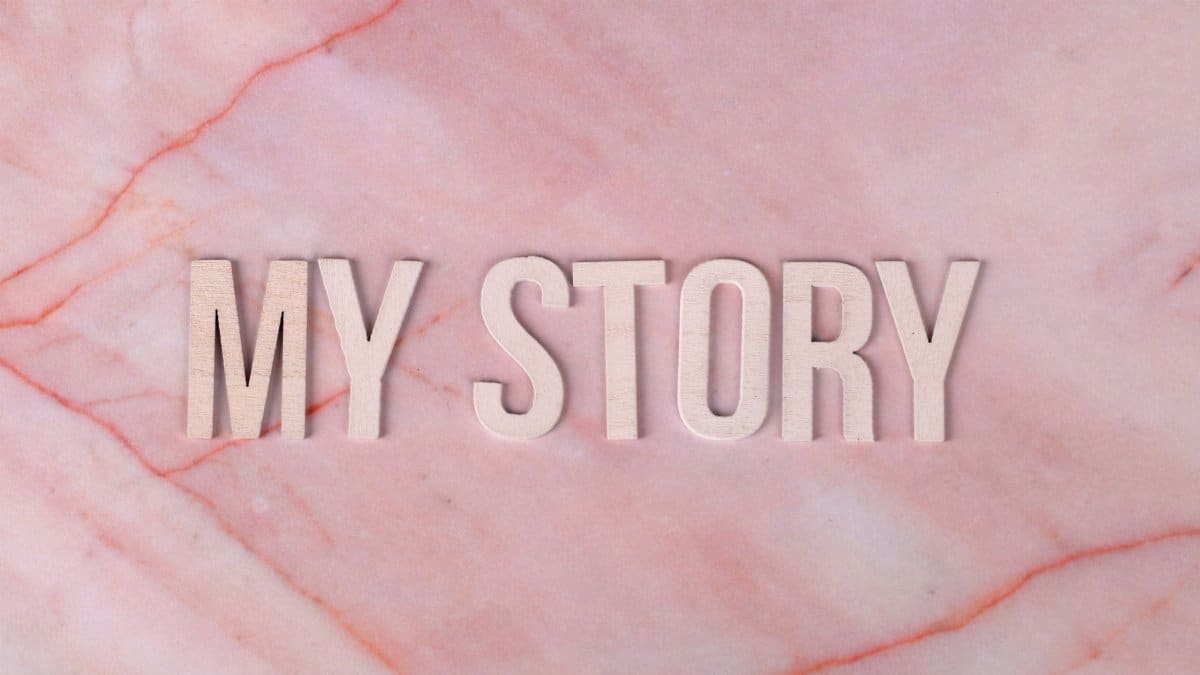 Text 'MY STORY' on a pink marble textured background, inspiring storytelling and creativity.