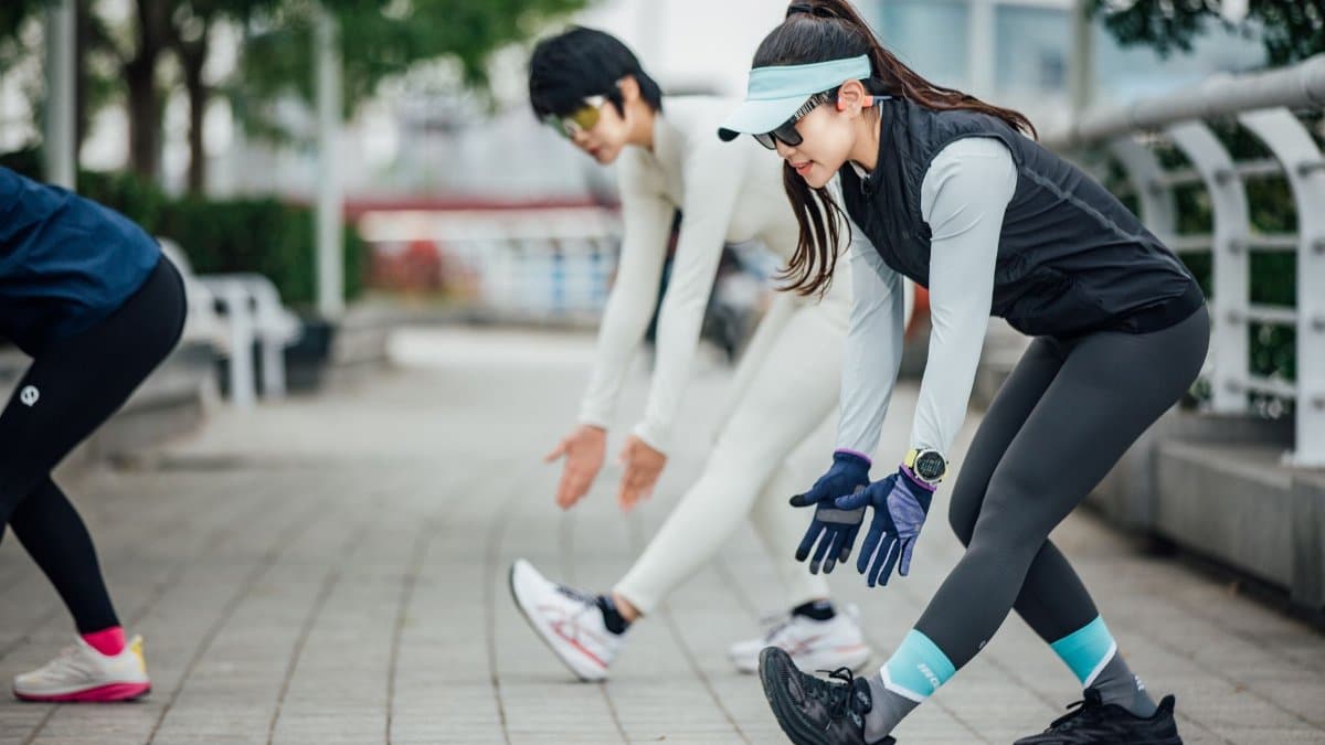 Active adults stretch during an outdoor workout session in an urban park setting.