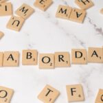 Labor Day spelled with Scrabble tiles on a marble surface, symbolizing celebration and creativity.