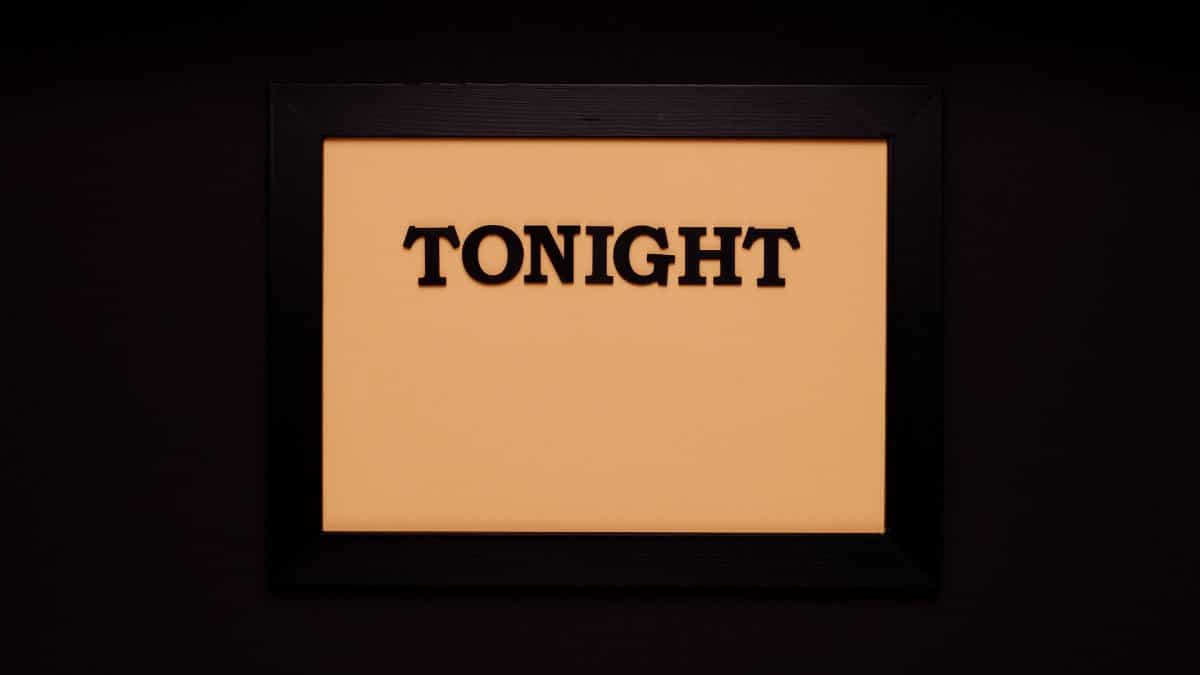 Minimalist framed sign with the word 'Tonight' on a solid black background.