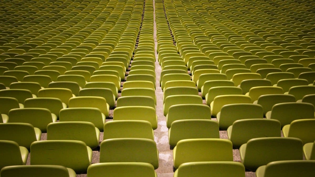 A captivating view of neatly arranged empty green seats in an auditorium.