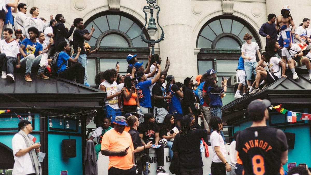 Lively crowd gathering on a city street during a sports event celebration, showcasing cultural diversity.