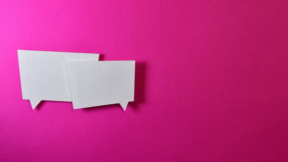 White speech bubbles on a vibrant pink background for communication or design concepts.
