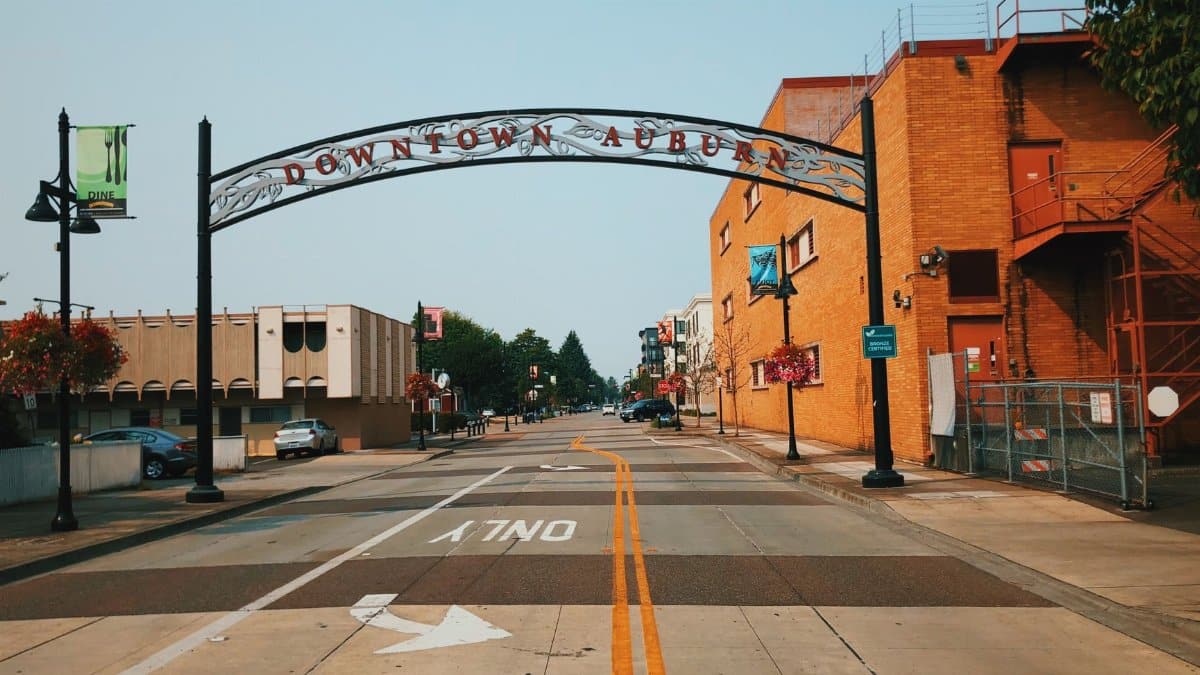 View of a street in downtown Auburn featuring an archway and urban architecture.