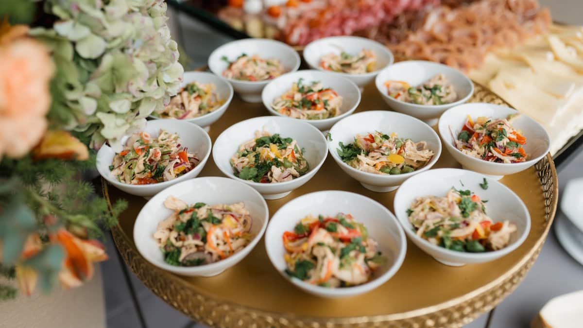 A buffet table with various delicious appetizers served in small bowls, perfect for events.