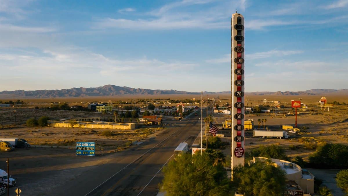 Aerial view of the World's Tallest Thermometer in Baker, California, along a desert highway.