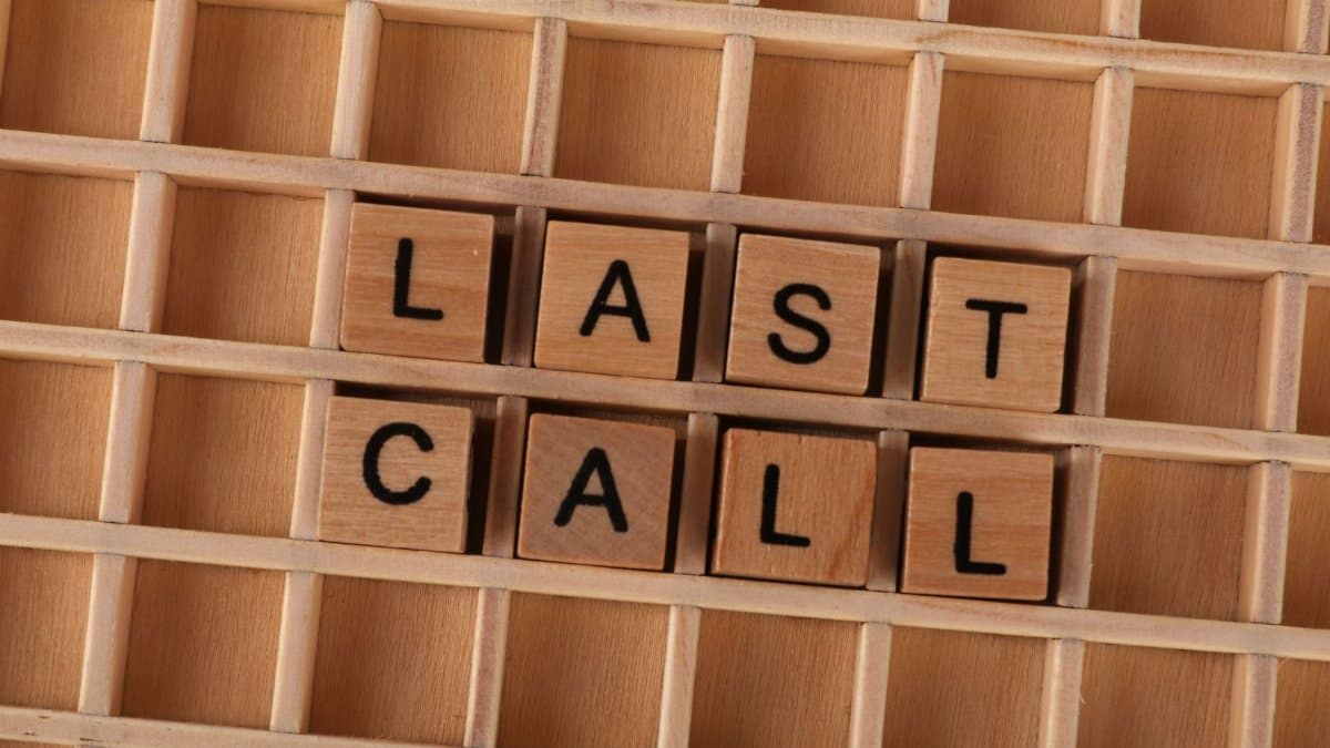 Wooden letter tiles forming the phrase 'Last Call' on a wooden background.