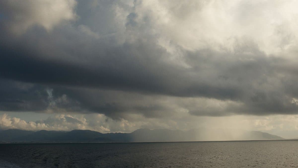 A vast ocean beneath a dramatic cloudy sky, perfect for conveying moody weather.