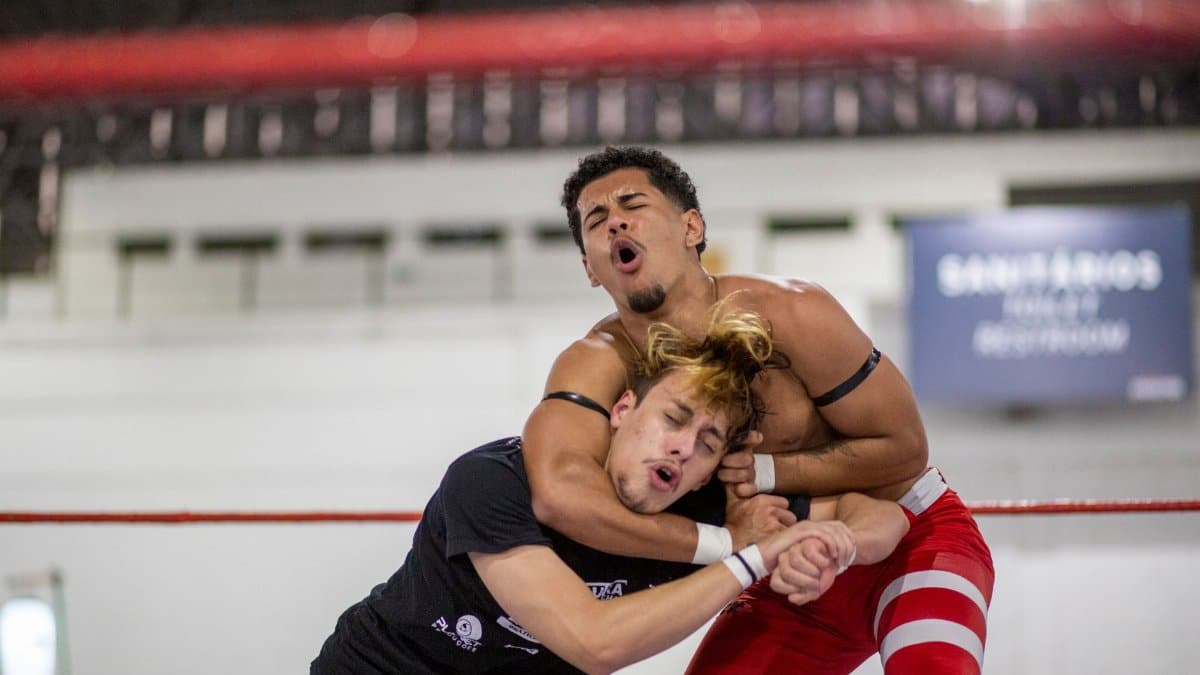 Two wrestlers in a dynamic match in Anhembi, São Paulo, showcasing strength and technique.