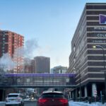 Snowy city street view featuring Minneapolis College and surrounding buildings in winter.