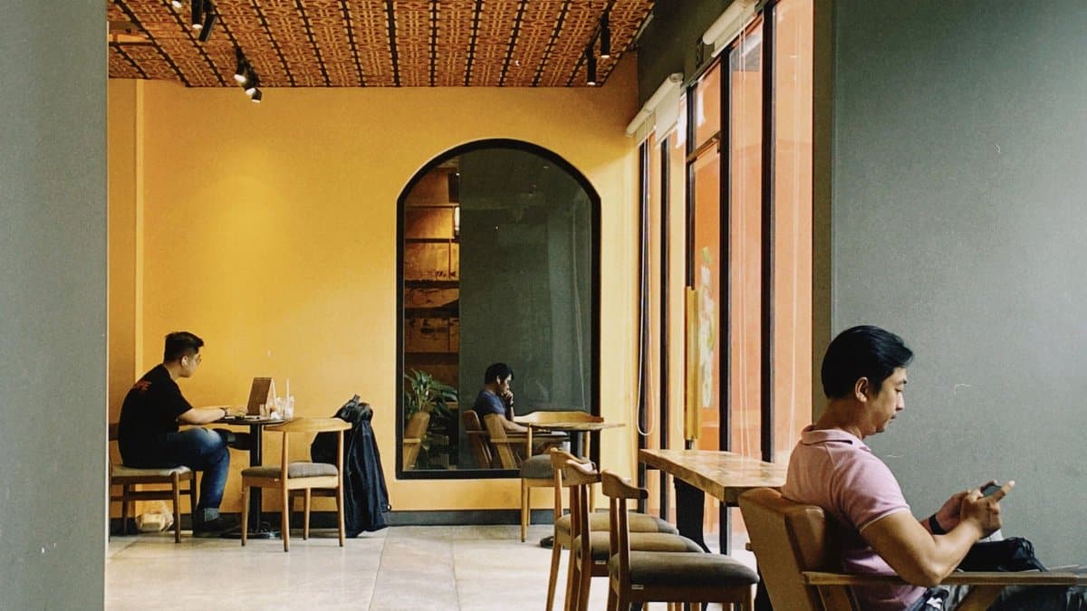 Warm café in Ho Chi Minh City with people enjoying work and relaxation.