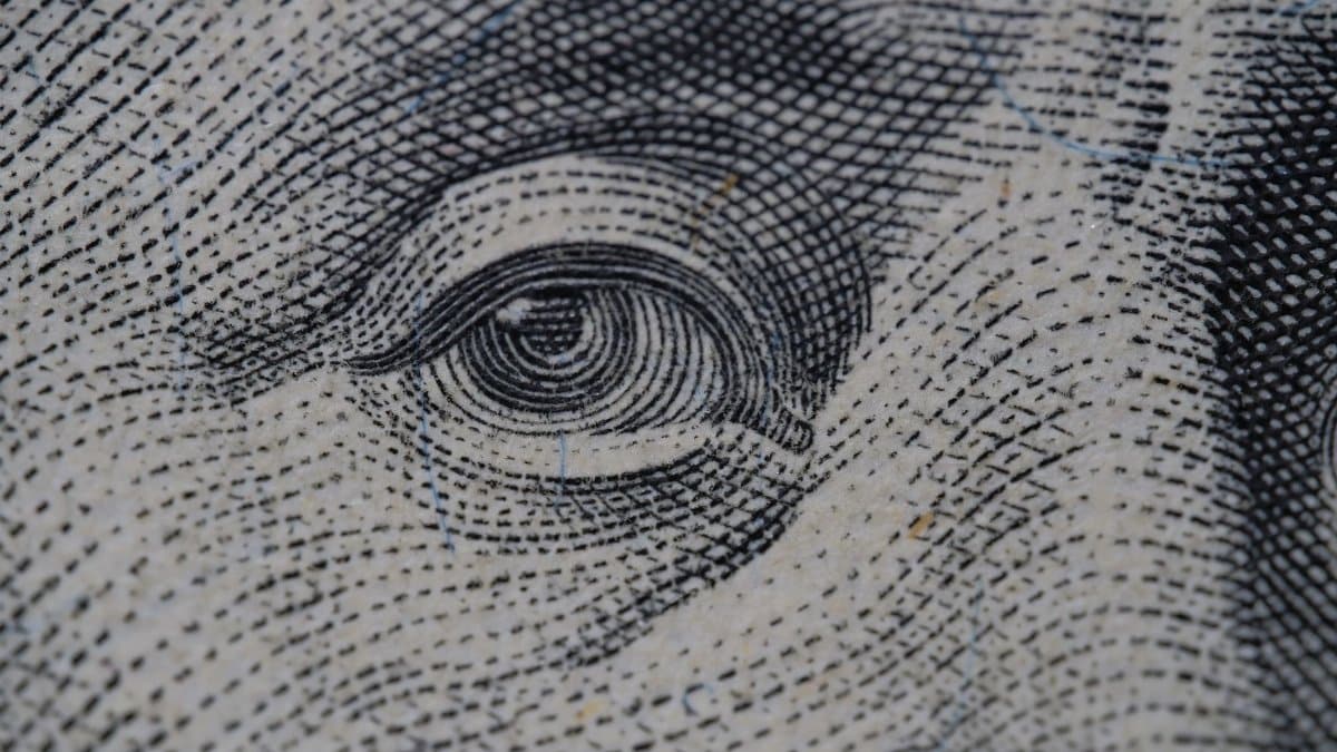 Detailed close-up of an illustration from a dollar bill, focusing on intricate line work.