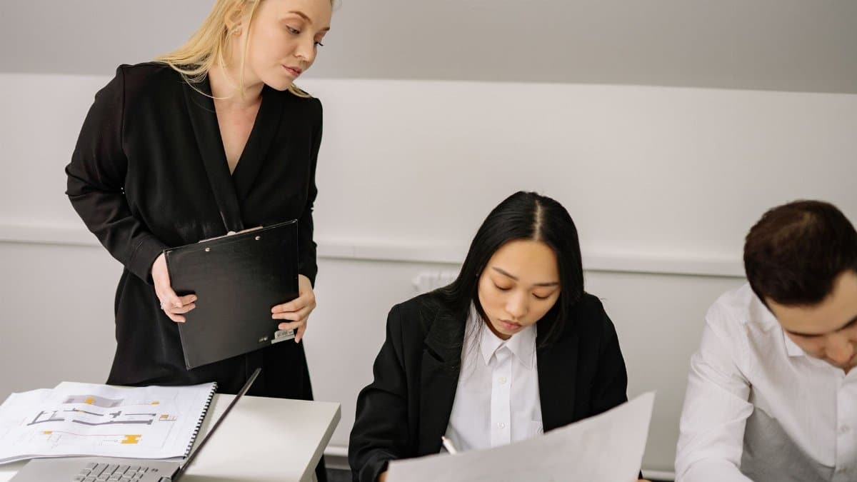 A diverse group of professionals engaged in a discussion during an office meeting.