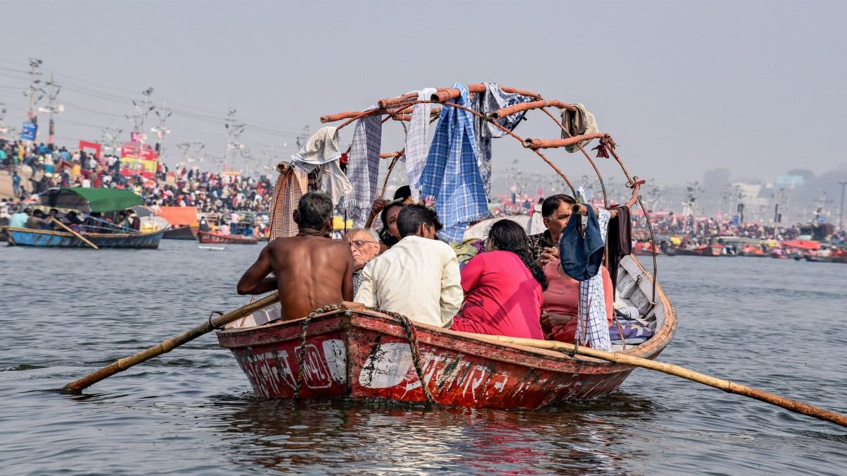 Group of people on a boat on the Ganges River in India, showcasing cultural travel.