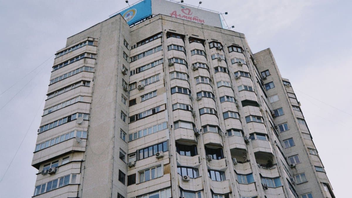 Concrete high-rise building with architectural details in Almaty, Kazakhstan.