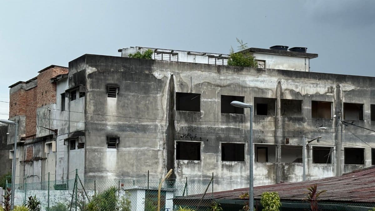 An abandoned building in Menglembu, Perak, showing urban decay with overcast skies.