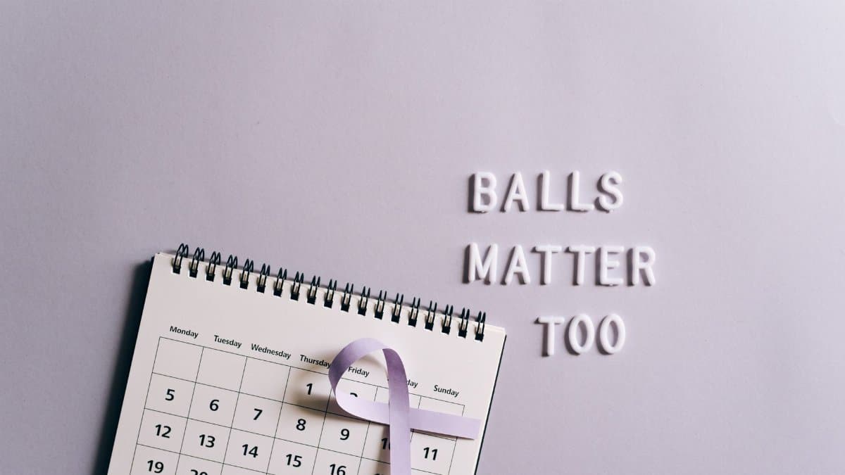 Calendar with ribbon promoting testicular cancer awareness on a light background.