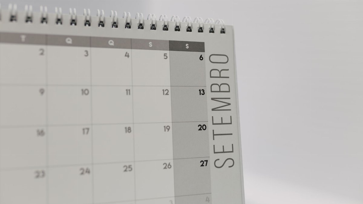 A desk calendar displaying the month of September with a spiral binding, in a minimalist design.