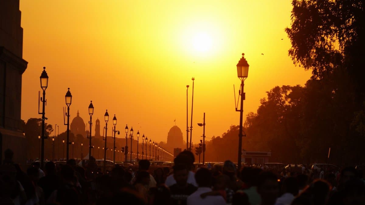 Crowded Rajpath at sunset offers a warm, vibrant view of India's architectural grandeur.