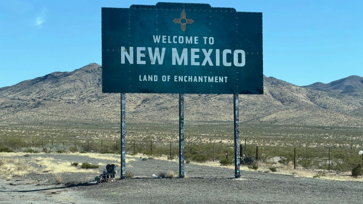 Iconic welcome sign for New Mexico in a desert landscape, tracing the state's enchanting charm.