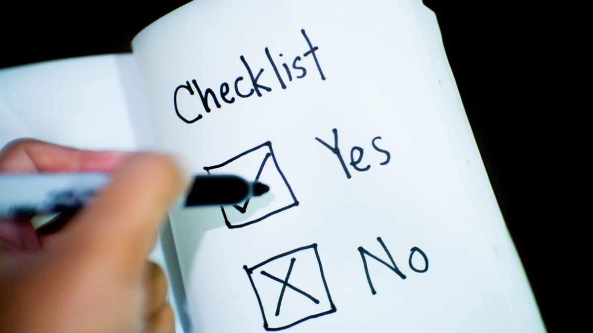 A notebook featuring a checklist with a marked 'Yes' box, captured in a close-up shot.